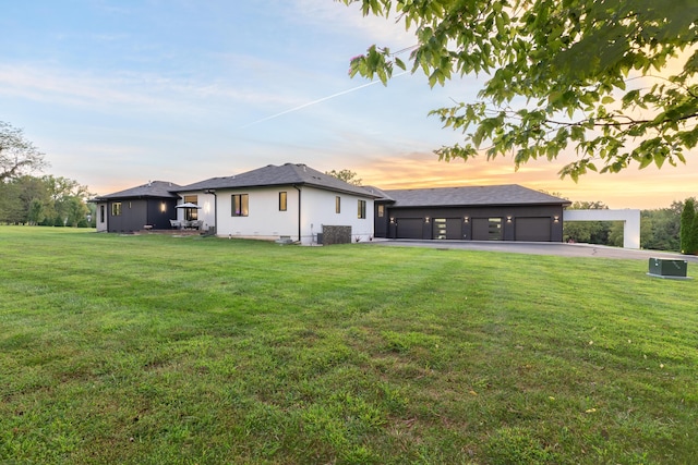 6298 E Summit View Dr, Springfield, MO 65809 - back of house at dusk featuring a yard and stucco siding
