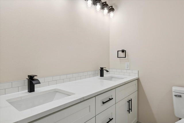 654 Rochester Rd, Sparta, MO 65753 - bathroom featuring double vanity and decorative backsplash