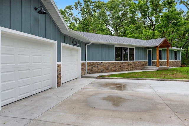 654 Rochester Rd, Sparta, MO 65753 - view of front of property featuring board and batten siding, stone siding, and an attached garage