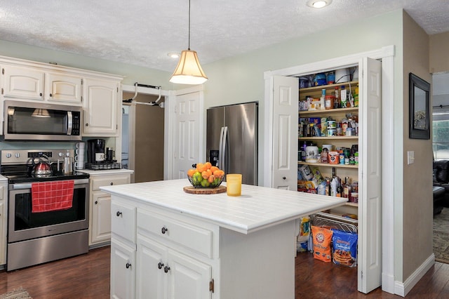 3711 W Farm Road 14, Brighton, MO 65617 - kitchen featuring stainless steel appliances, tile countertops, dark wood-type flooring, white cabinetry, and a textured ceiling