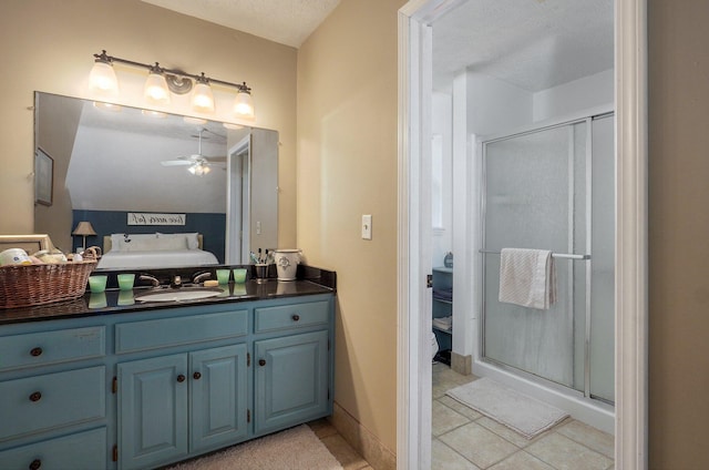 3711 W Farm Road 14, Brighton, MO 65617 - bathroom featuring a ceiling fan, a stall shower, vanity, tile patterned flooring, and a textured ceiling