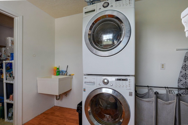 3711 W Farm Road 14, Brighton, MO 65617 - washroom featuring stacked washer / drying machine, wood finished floors, and a textured ceiling
