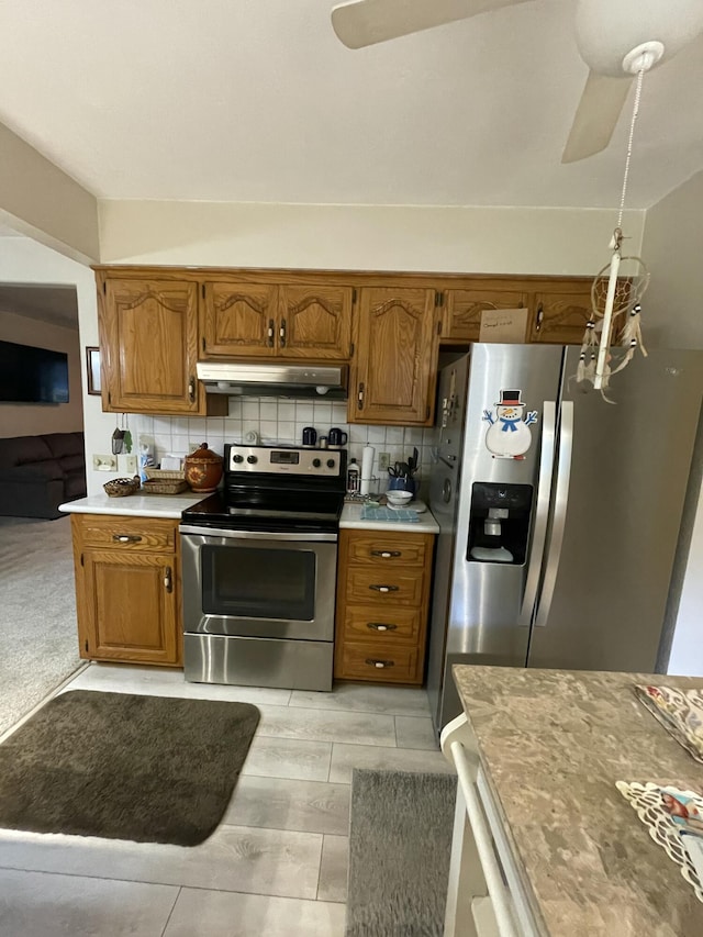 2105 Oakridge Dr, Ava, MO 65608 - kitchen with stainless steel appliances, a ceiling fan, under cabinet range hood, and brown cabinetry