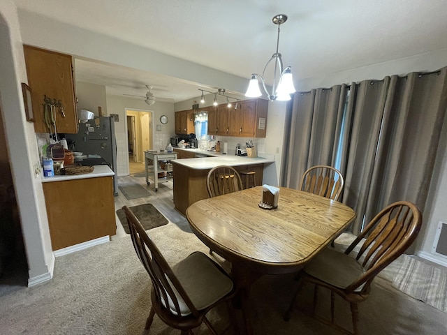 2105 Oakridge Dr, Ava, MO 65608 - dining room featuring light colored carpet, a chandelier, and rail lighting
