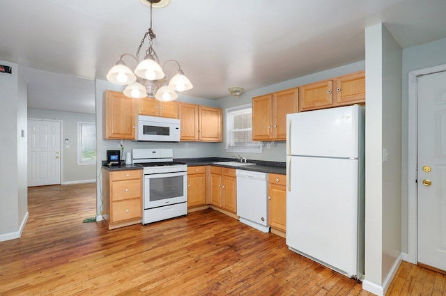 921 S Nettleton Ave, Springfield, MO 65806 - kitchen with white appliances, light brown cabinetry, and a chandelier