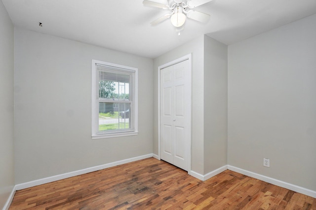 921 S Nettleton Ave, Springfield, MO 65806 - unfurnished bedroom featuring wood finished floors, a closet, and a ceiling fan