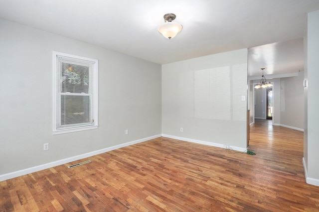 921 S Nettleton Ave, Springfield, MO 65806 - spare room with a chandelier and wood finished floors