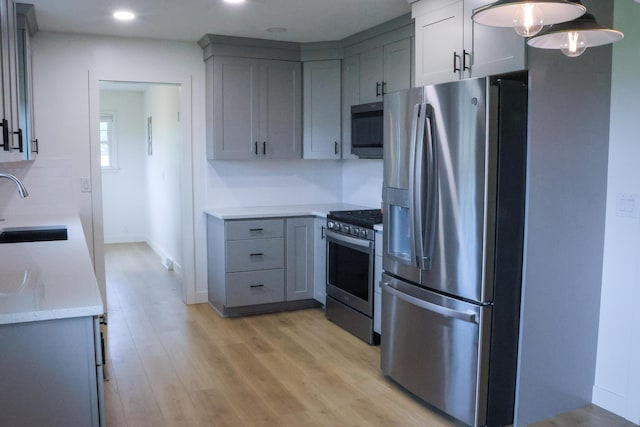 325 N Delaware Ave, Nixa, MO 65714 - kitchen with stainless steel appliances, gray cabinetry, light wood-type flooring, recessed lighting, and decorative backsplash