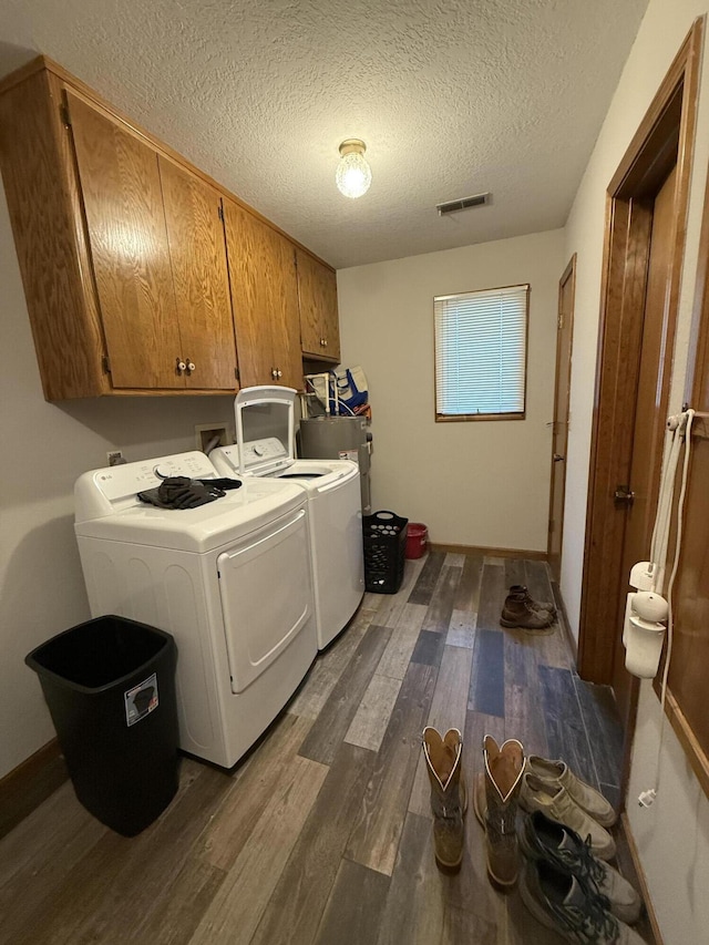1301 W Blair Dr, Stockton, MO 65785 - laundry room with cabinet space, dark wood-type flooring, separate washer and dryer, and a textured ceiling