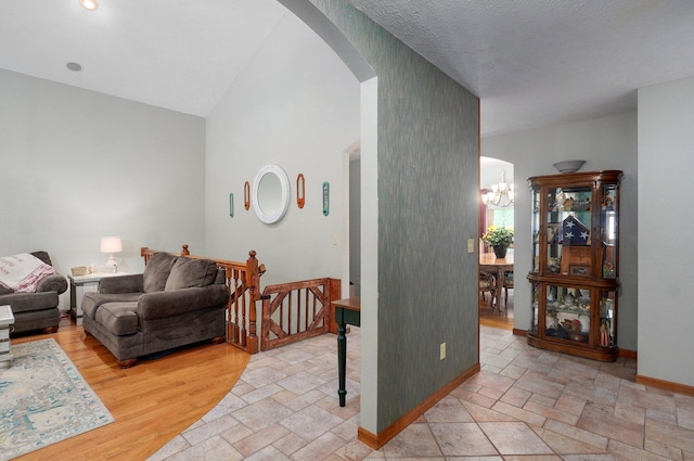 5150 S Dollison Ave, Springfield, MO 65810 - living area with arched walkways, stone tile flooring, a chandelier, and vaulted ceiling