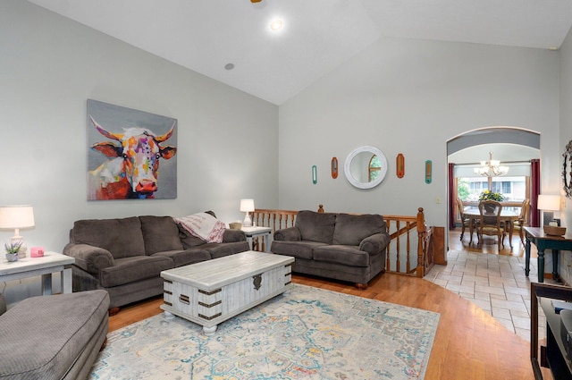 5150 S Dollison Ave, Springfield, MO 65810 - living area with arched walkways, high vaulted ceiling, light wood-style floors, and a chandelier