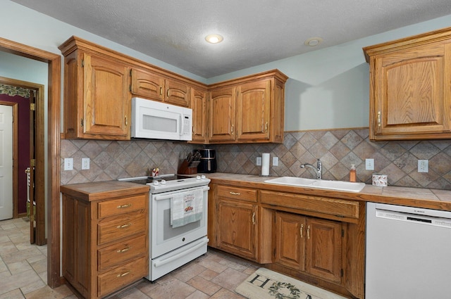 5150 S Dollison Ave, Springfield, MO 65810 - kitchen featuring white appliances, tile countertops, stone tile flooring, decorative backsplash, and a textured ceiling