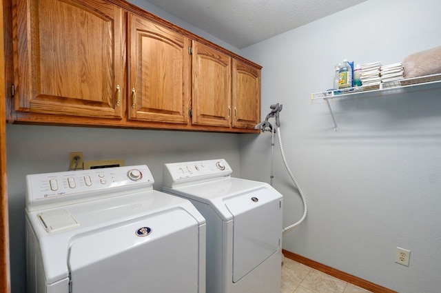 5150 S Dollison Ave, Springfield, MO 65810 - laundry room with independent washer and dryer, cabinet space, and light tile patterned floors