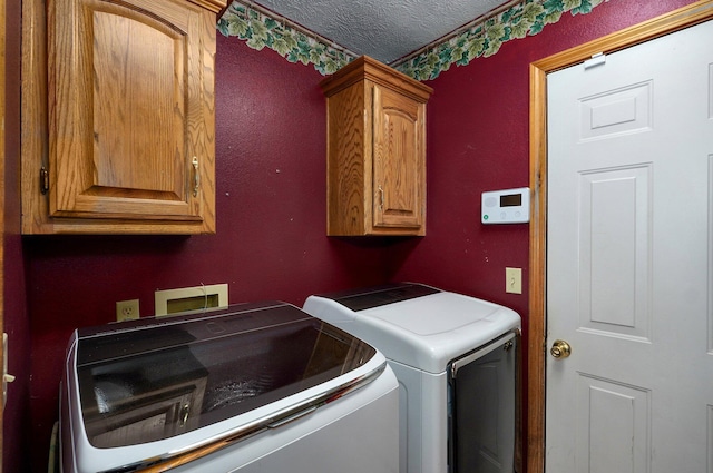 5150 S Dollison Ave, Springfield, MO 65810 - laundry area featuring separate washer and dryer, cabinet space, and a textured ceiling