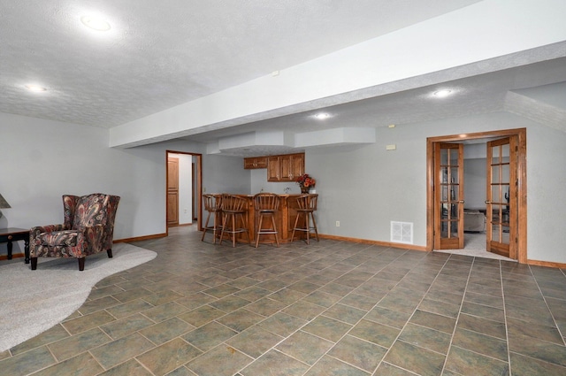 5150 S Dollison Ave, Springfield, MO 65810 - finished basement with bar area, a textured ceiling, and recessed lighting