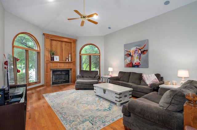 5150 S Dollison Ave, Springfield, MO 65810 - living area featuring lofted ceiling, a fireplace, ceiling fan, and light wood finished floors