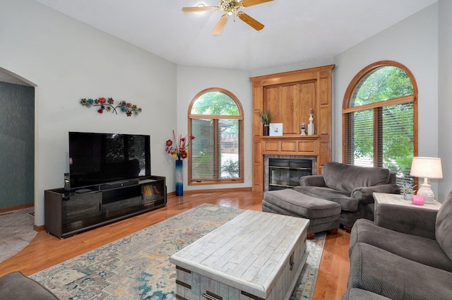 5150 S Dollison Ave, Springfield, MO 65810 - living area with a ceiling fan, a large fireplace, light wood-type flooring, and arched walkways