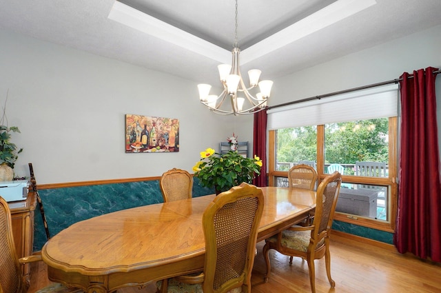 5150 S Dollison Ave, Springfield, MO 65810 - dining room with a chandelier, light wood finished floors, and a raised ceiling