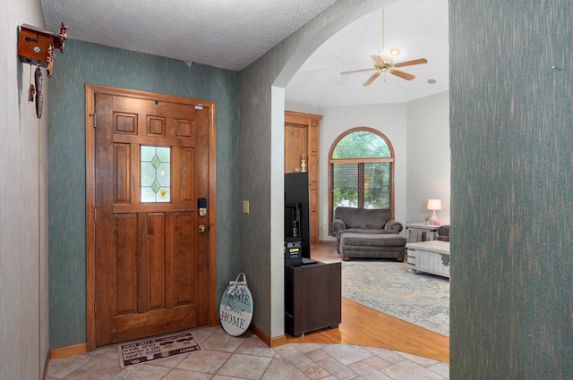 5150 S Dollison Ave, Springfield, MO 65810 - entrance foyer featuring arched walkways, a ceiling fan, and light wood-type flooring