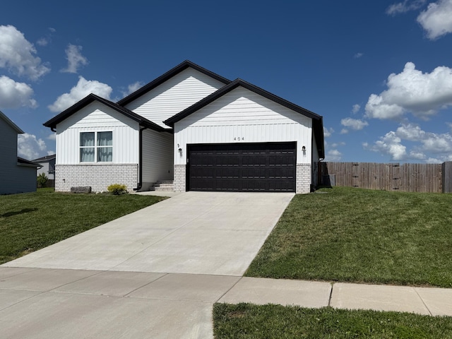 404 N Pine Leaf Rd, Nixa, MO 65714 - view of front facade featuring a garage, brick siding, concrete driveway, and board and batten siding