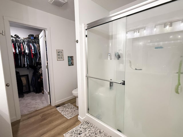 404 N Pine Leaf Rd, Nixa, MO 65714 - bathroom featuring wood finished floors, a stall shower, and a walk in closet