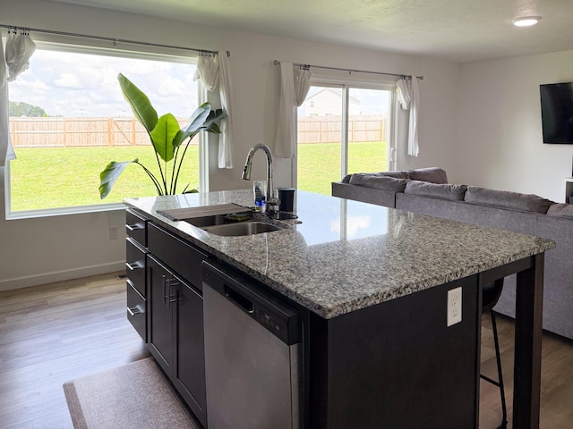 404 N Pine Leaf Rd, Nixa, MO 65714 - kitchen featuring dishwasher, light wood-style flooring, dark cabinetry, open floor plan, and stone countertops