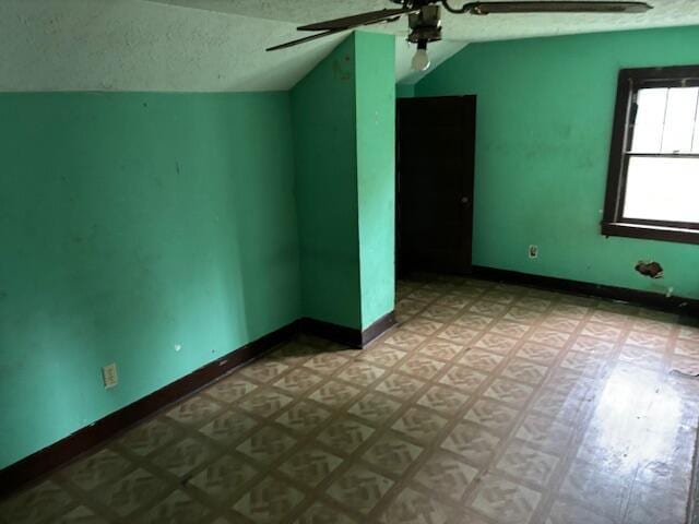 148 E Front St, Fordland, MO 65652 - spare room with lofted ceiling, a ceiling fan, and a textured ceiling