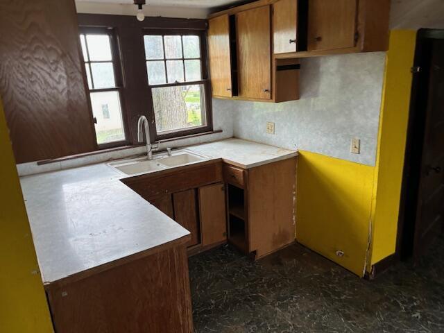 148 E Front St, Fordland, MO 65652 - kitchen with plenty of natural light, brown cabinetry, and light countertops