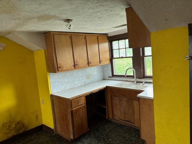 148 E Front St, Fordland, MO 65652 - kitchen featuring brown cabinets, light countertops, and a textured ceiling