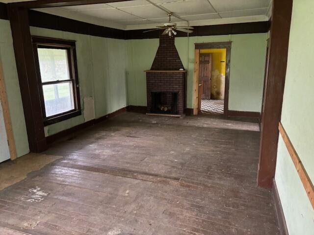 148 E Front St, Fordland, MO 65652 - unfurnished living room featuring a ceiling fan, hardwood / wood-style floors, and a fireplace