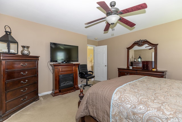 1704 Luna Dr, West Plains, MO 65775 - bedroom featuring light carpet, a glass covered fireplace, and ceiling fan
