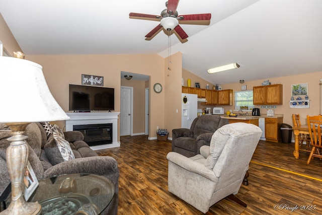 1704 Luna Dr, West Plains, MO 65775 - living area with dark wood finished floors, a ceiling fan, lofted ceiling, and a glass covered fireplace