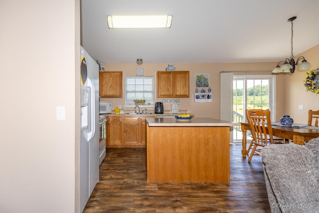 1704 Luna Dr, West Plains, MO 65775 - kitchen featuring a kitchen island, white microwave, a chandelier, freestanding refrigerator, and dark wood-style floors