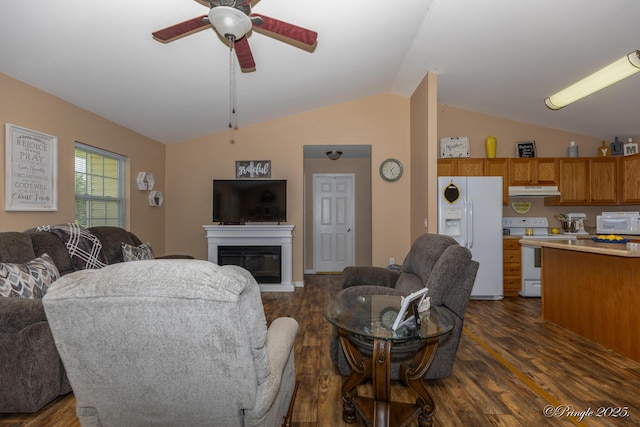 1704 Luna Dr, West Plains, MO 65775 - living room featuring a ceiling fan, dark wood-style flooring, vaulted ceiling, and a glass covered fireplace