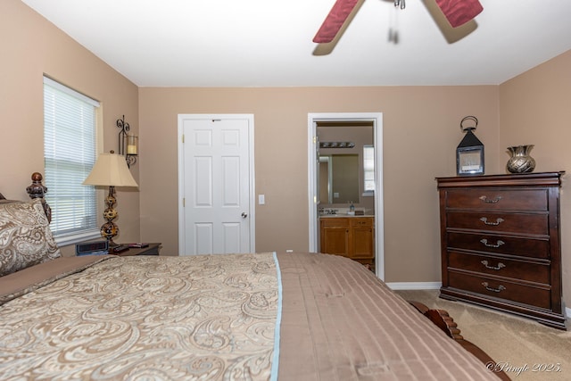 1704 Luna Dr, West Plains, MO 65775 - carpeted bedroom with multiple windows, connected bathroom, and ceiling fan