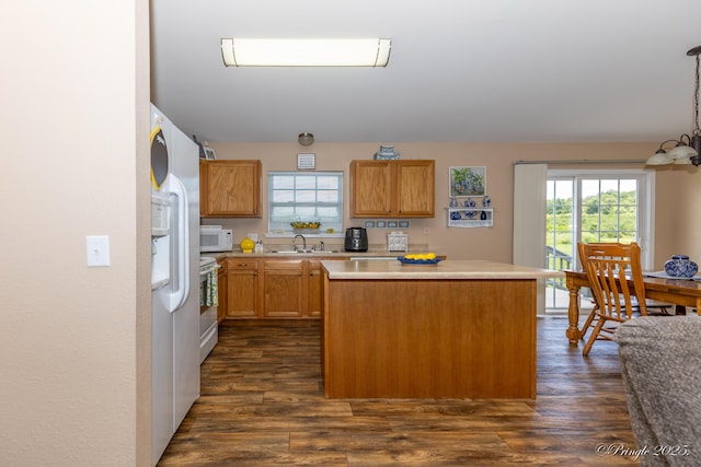 1704 Luna Dr, West Plains, MO 65775 - kitchen featuring white appliances, a center island, light countertops, and dark wood-style flooring
