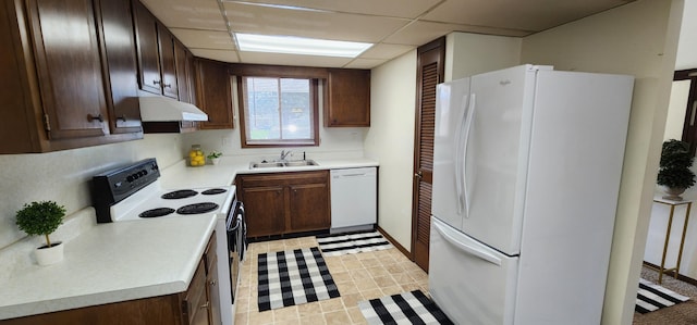 16 Magnolia Ct Unit B, Branson, MO 65616 - kitchen featuring white appliances, under cabinet range hood, light countertops, dark brown cabinets, and a paneled ceiling