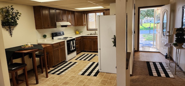 16 Magnolia Ct Unit B, Branson, MO 65616 - kitchen with white appliances, under cabinet range hood, light countertops, plenty of natural light, and a drop ceiling