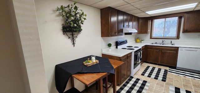 16 Magnolia Ct Unit B, Branson, MO 65616 - kitchen with white appliances, under cabinet range hood, light countertops, dark brown cabinetry, and light tile patterned floors