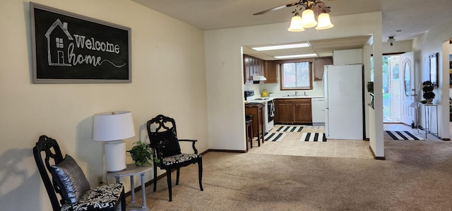 16 Magnolia Ct Unit B, Branson, MO 65616 - kitchen featuring white appliances, light carpet, light countertops, ceiling fan, and extractor fan