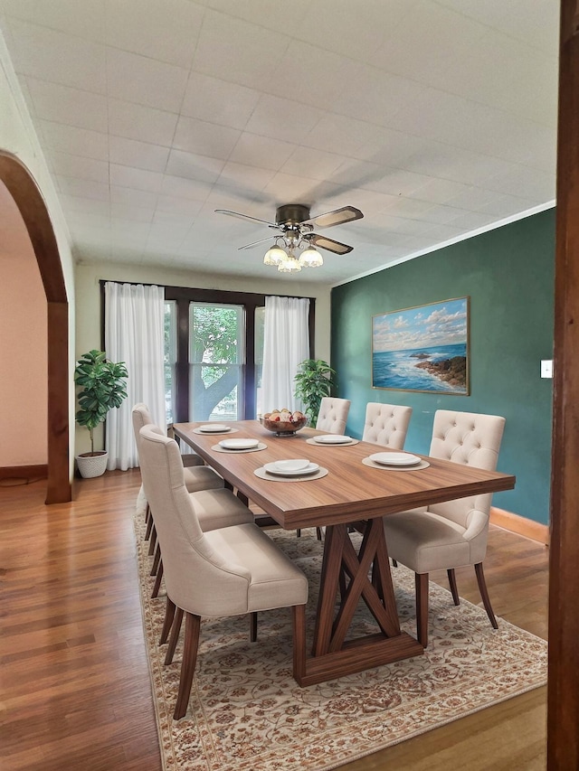 505 Sycamore St, Van Buren, MO 63965 - dining space featuring wood finished floors, arched walkways, and a ceiling fan