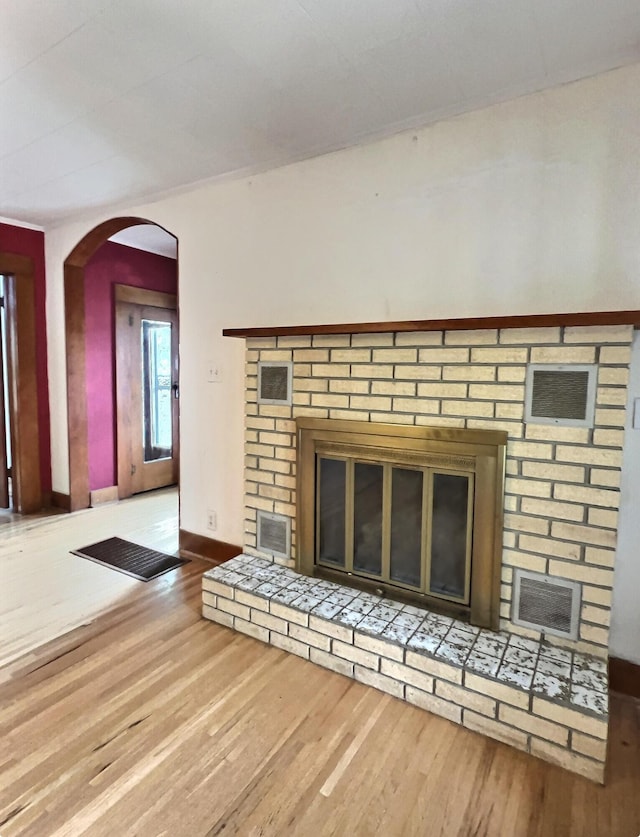 505 Sycamore St, Van Buren, MO 63965 - detailed view of a brick fireplace, wood finished floors, and arched walkways