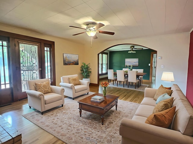 505 Sycamore St, Van Buren, MO 63965 - living area featuring arched walkways, ceiling fan, wood finished floors, and plenty of natural light