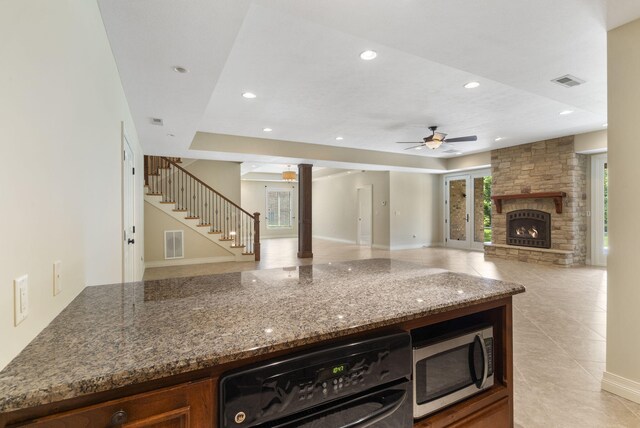 755 N Fallbrooke Ter, Springfield, MO 65802 - kitchen featuring stainless steel microwave, ceiling fan, a stone fireplace, stone counters, and recessed lighting