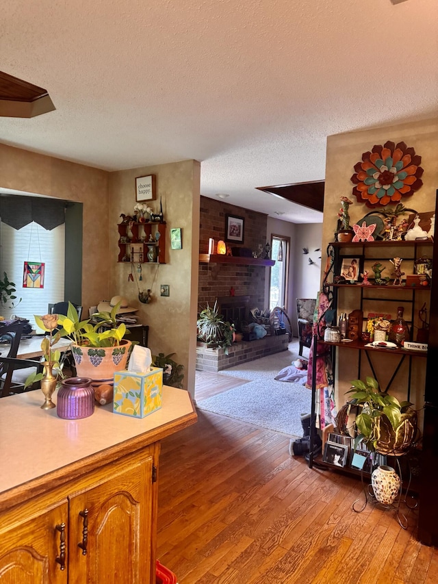1249 Stonebrook Rd, Ozark, MO 65721 - living room featuring a textured ceiling, light wood-style flooring, and a fireplace