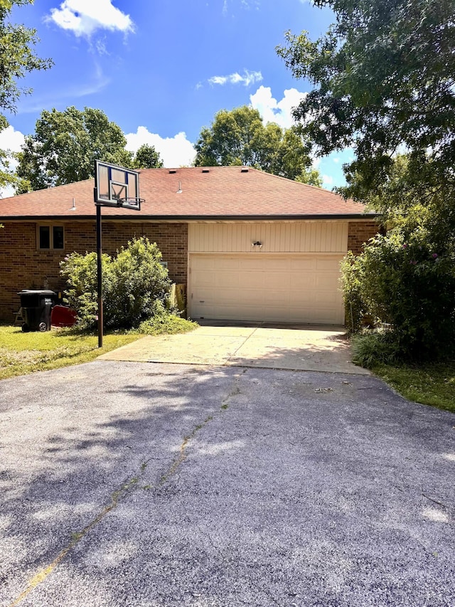 1249 Stonebrook Rd, Ozark, MO 65721 - view of side of property with asphalt driveway, an attached garage, and brick siding