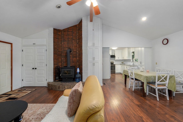 263 Crystal Ave, Sparta, MO 65753 - living room with a ceiling fan, dark wood-style floors, high vaulted ceiling, and a wood stove