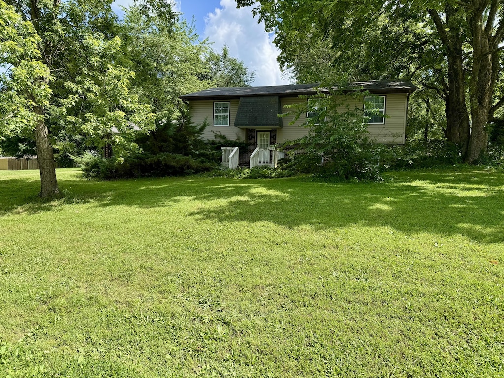 2204 Lambe Ave, West Plains, MO 65775 - rear view of property with a lawn