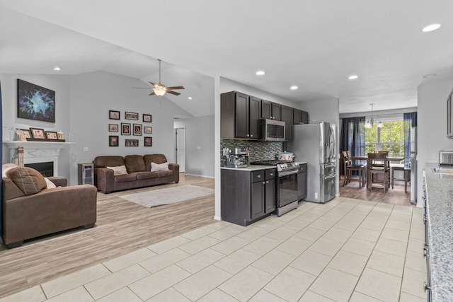 1917 Willoughby Rd, Clever, MO 65631 - kitchen featuring appliances with stainless steel finishes, light tile patterned flooring, light countertops, vaulted ceiling, and recessed lighting
