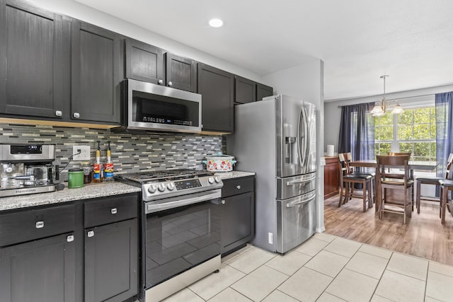 1917 Willoughby Rd, Clever, MO 65631 - kitchen featuring stainless steel appliances, tasteful backsplash, pendant lighting, light tile patterned flooring, and light stone counters